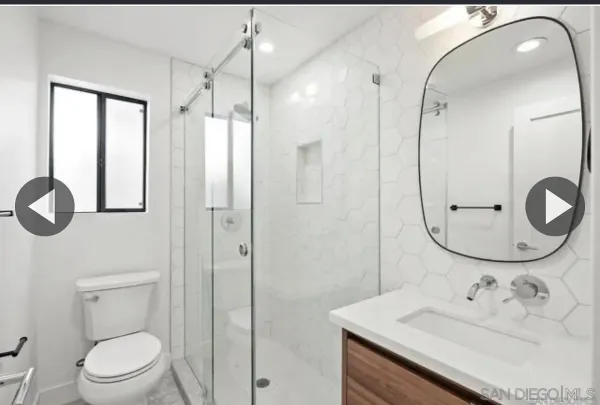 a bathroom with a sink a toilet and a mirror