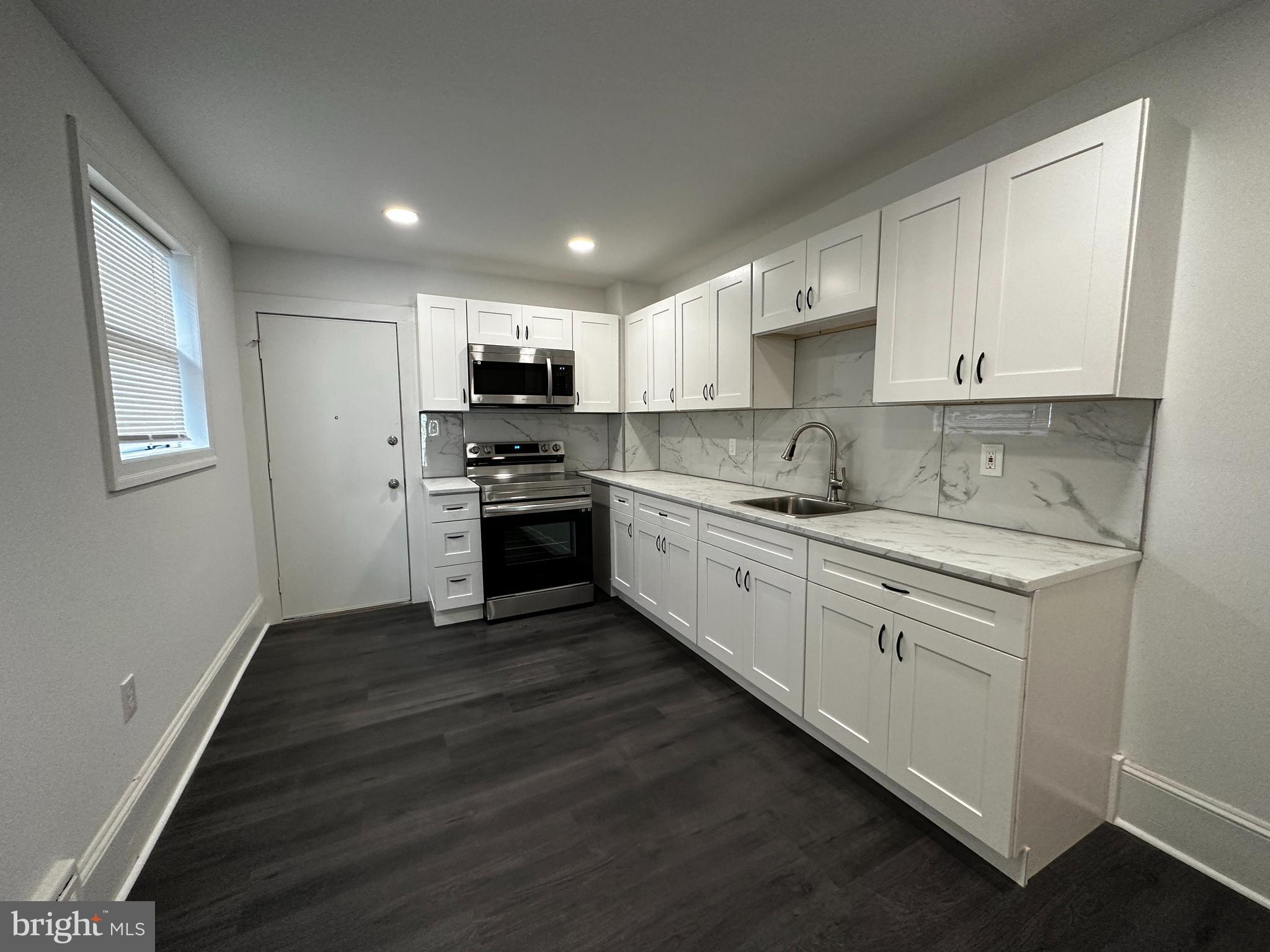 342 Valley Road Coatesville, PA 19320 - Photo 2 of 9 a kitchen with stainless steel appliances granite countertop a stove sink and cabinets