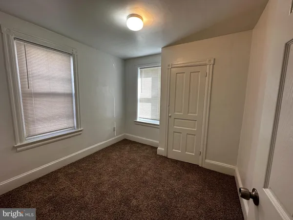 a view of an empty room with stairs