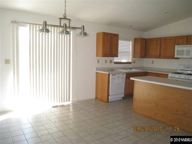 1690 Laiolo Drive Reno, NV 89502 - Photo 3 of 6 a kitchen with stainless steel appliances granite countertop a stove a sink and a refrigerator