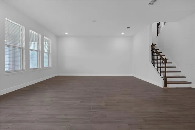 a view of wooden floor and windows in a room