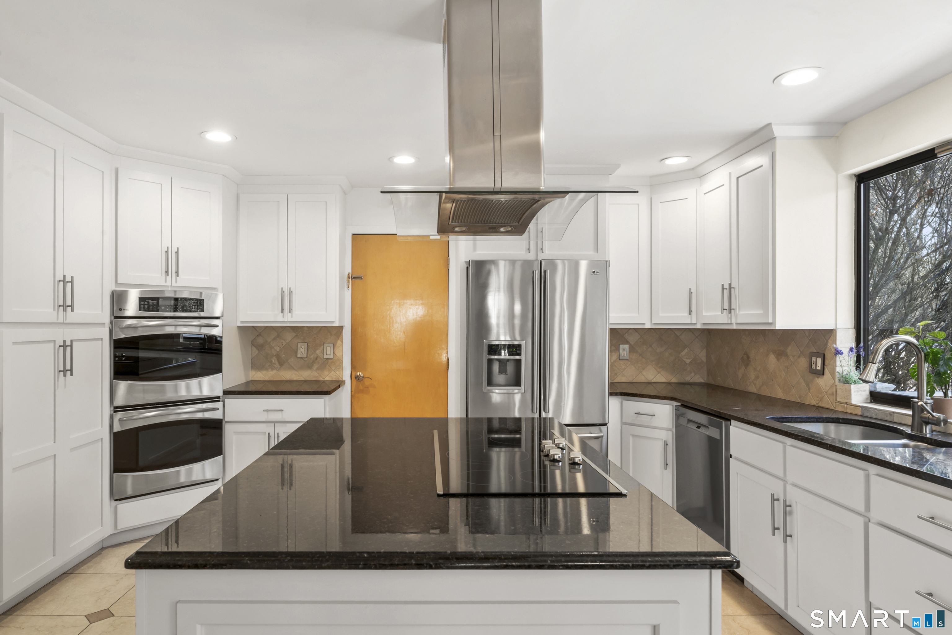 211 Pinewood Road Stamford, CT 06903 - Photo 13 of 38 a kitchen with kitchen island granite countertop a sink appliances and cabinets