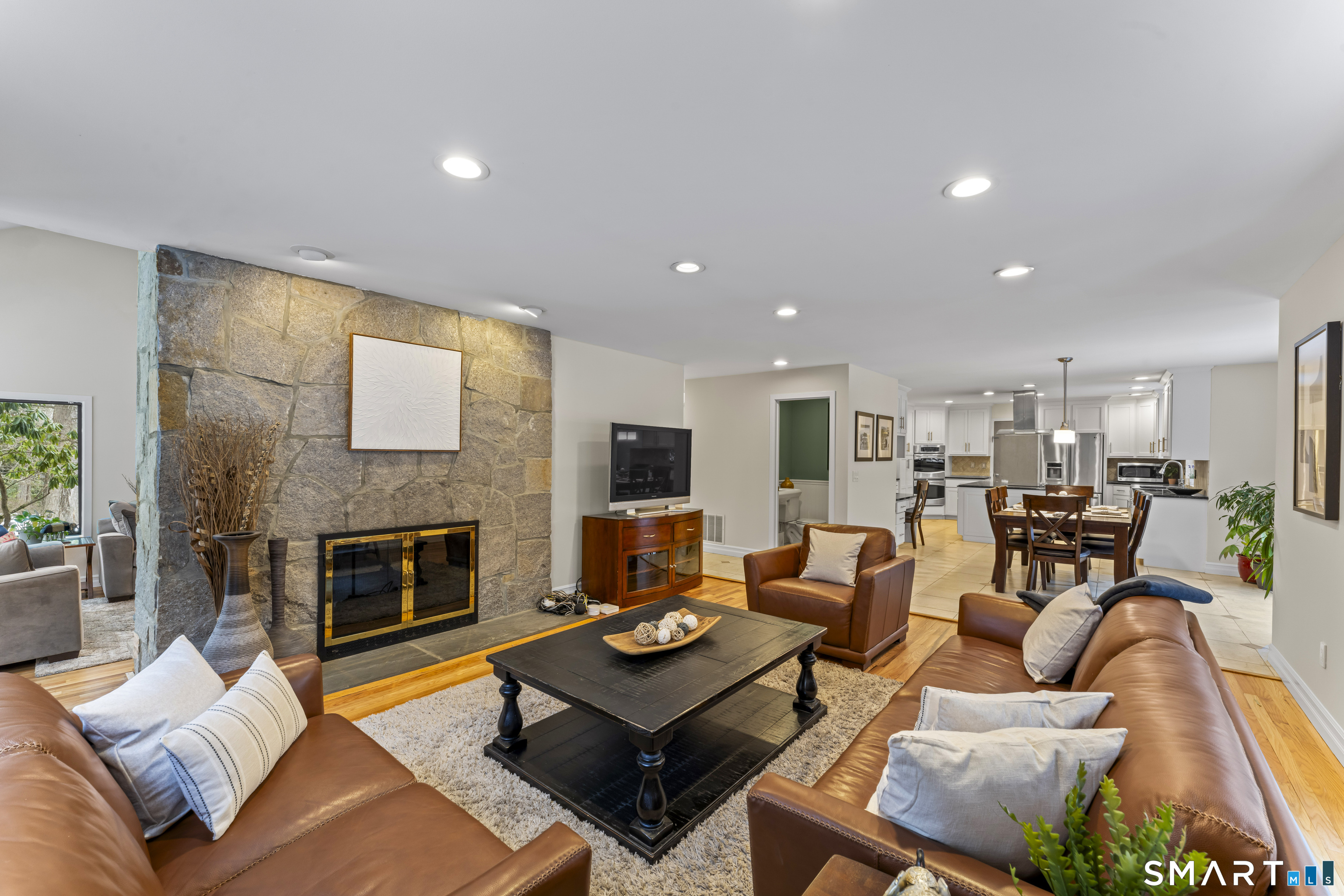 211 Pinewood Road Stamford, CT 06903 - Photo 16 of 38 a living room with furniture kitchen view and a fireplace