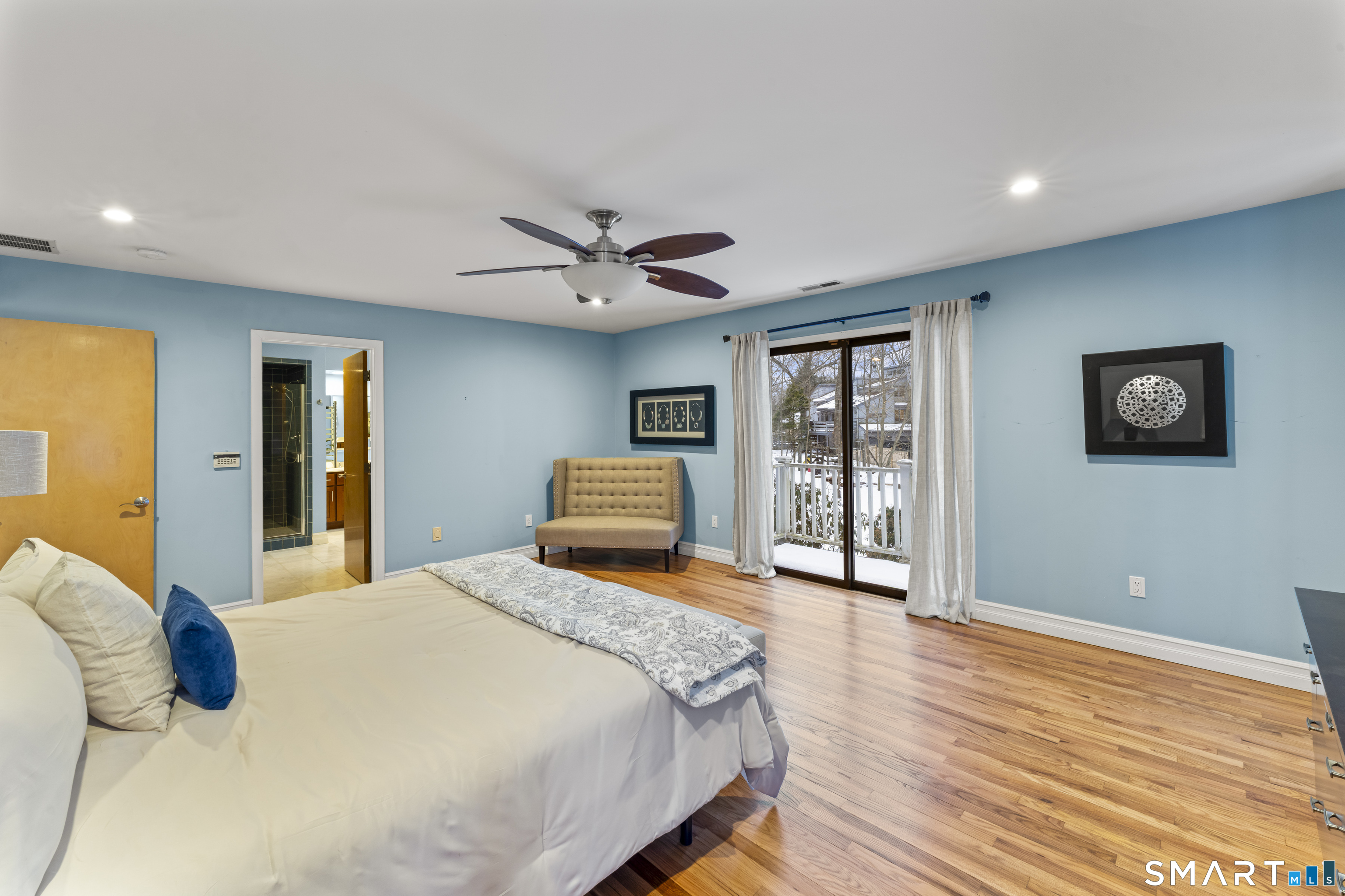 211 Pinewood Road Stamford, CT 06903 - Photo 22 of 38 a bedroom with a large bed and a chandelier