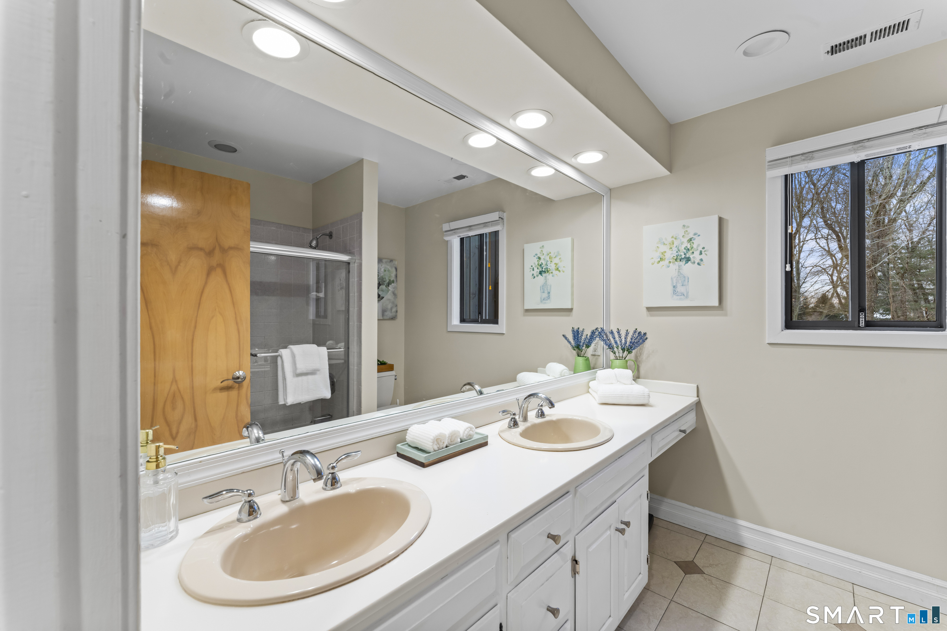 211 Pinewood Road Stamford, CT 06903 - Photo 30 of 38 a bathroom with a double vanity sink and a mirror