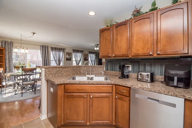 a kitchen with granite countertop a sink stove and cabinets