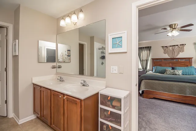 a en suite bathroom with a sink double vanity and a mirror