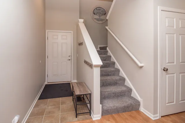 a view of entryway and hall with wooden floor