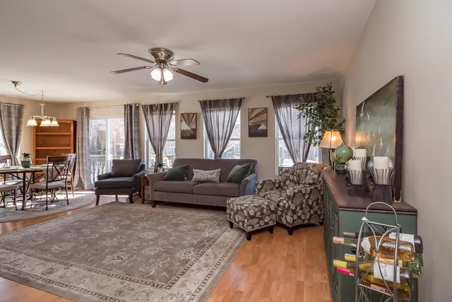 a living room with furniture and a chandelier