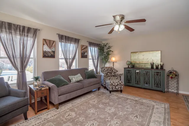 a living room with furniture and a chandelier