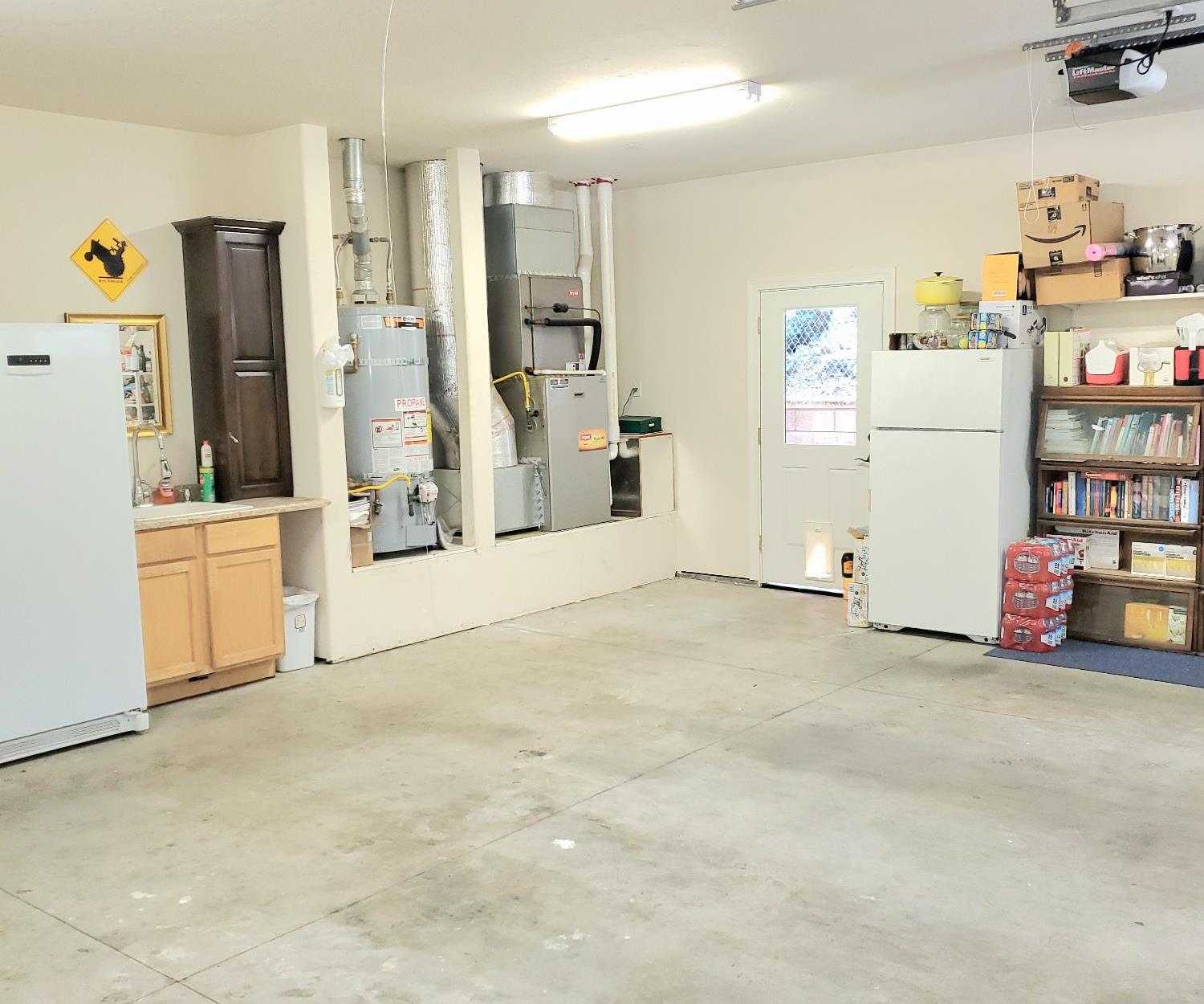 1440 Dog Bar Road Colfax, CA 95713 - Photo 69 of 93 Spacious garage with gas water heater, central heating unit, and garage door opener