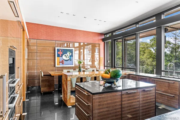 a living room with furniture and large windows