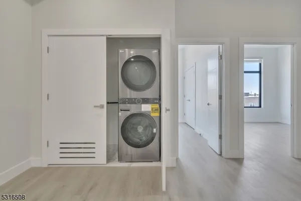 a view of a hallway with washer and dryer