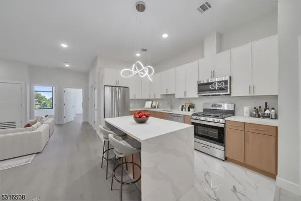 a kitchen that has a lot of cabinets in it and appliances