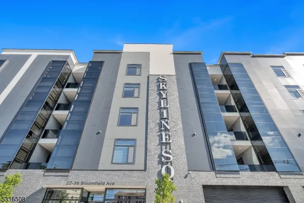 a view of a hallway with wooden floor and a chandelier