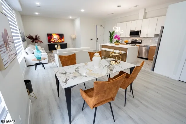 a view of a dining room with furniture and a kitchen