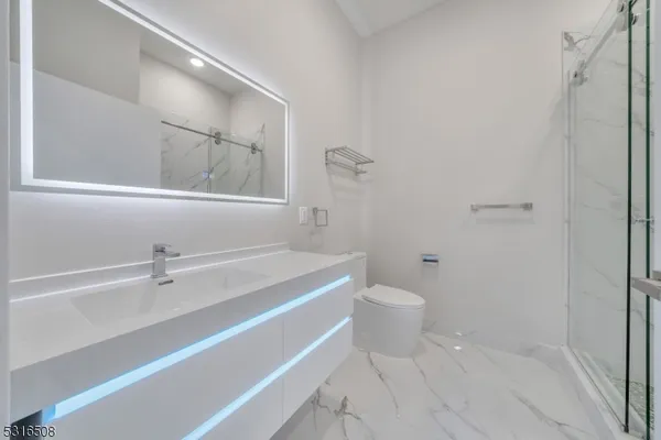 a bathroom with a sink a toilet and a mirror