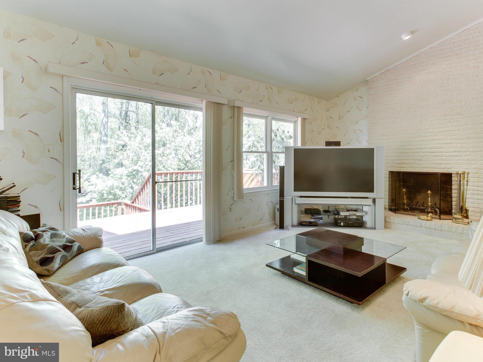 10 Deckman Court Silver Spring, MD 20906 - Photo 12 of 25 a living room with furniture a flat screen tv and a large window