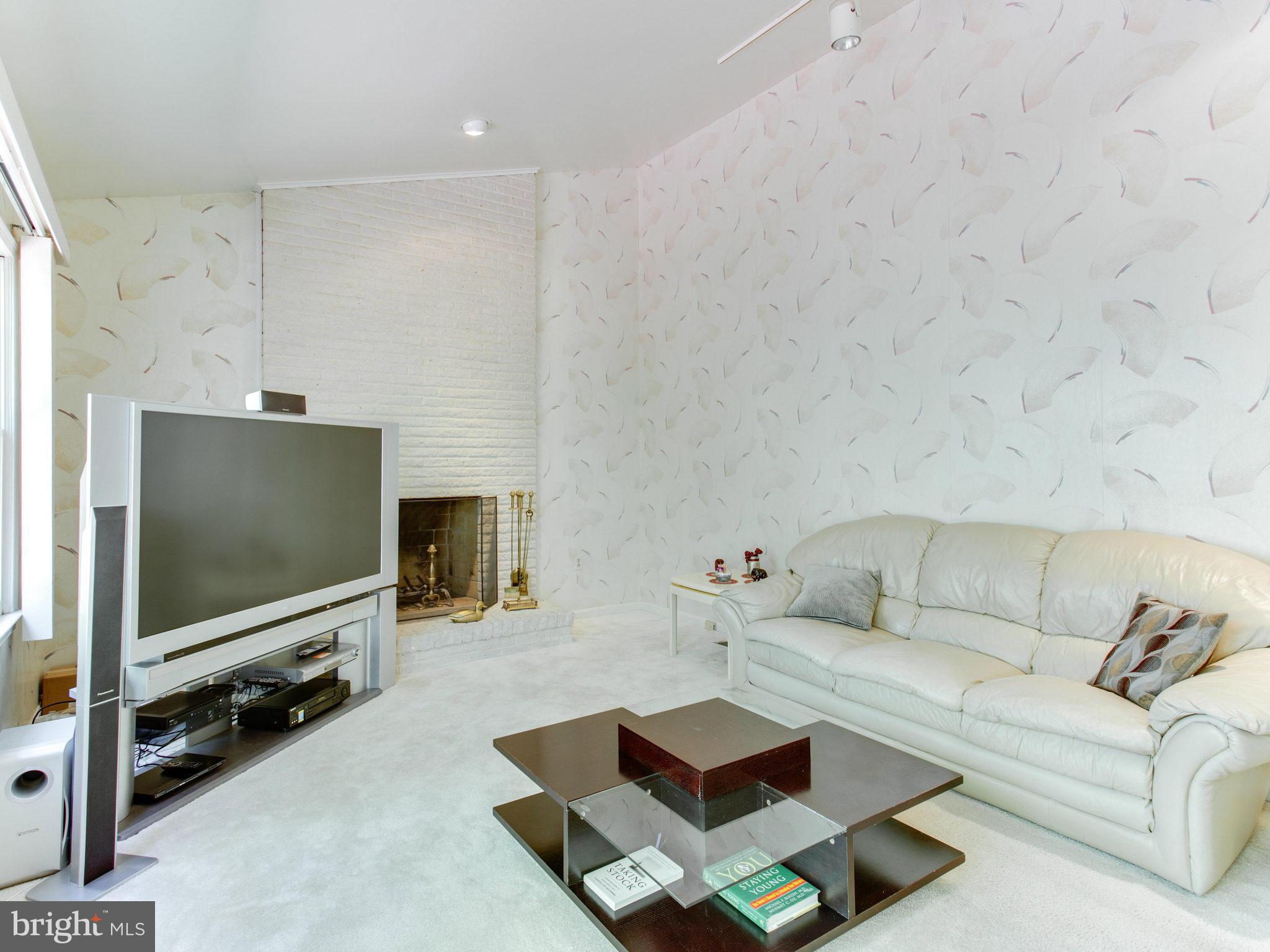 10 Deckman Court Silver Spring, MD 20906 - Photo 15 of 25 a living room with furniture and a flat screen tv