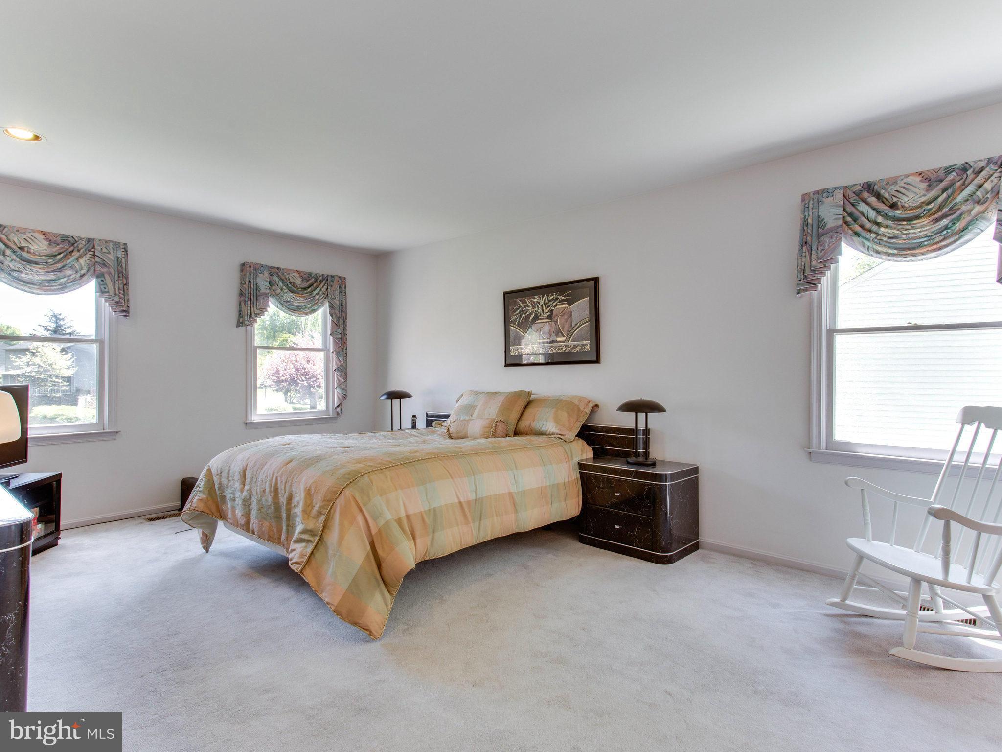 10 Deckman Court Silver Spring, MD 20906 - Photo 19 of 25 a spacious bedroom with a bed and a window