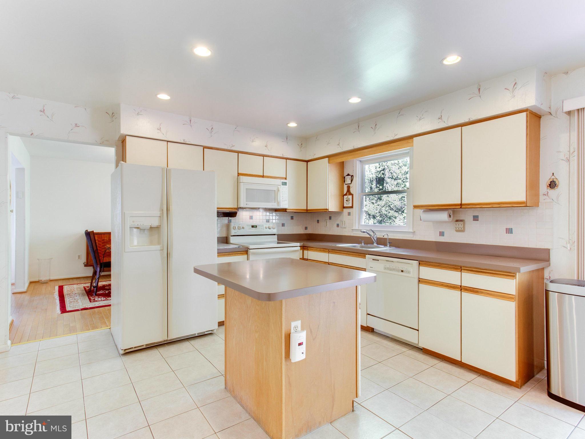 10 Deckman Court Silver Spring, MD 20906 - Photo 9 of 25 a kitchen with stainless steel appliances a refrigerator sink and cabinets