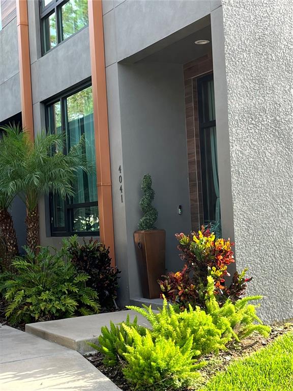a front view of a house with a lot of flower and wooden fence