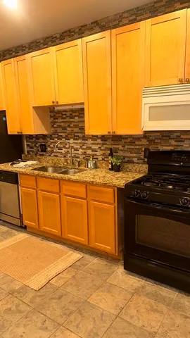 a kitchen with stainless steel appliances granite countertop a stove and a sink