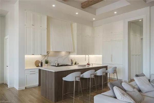a kitchen with granite countertop a table and chairs