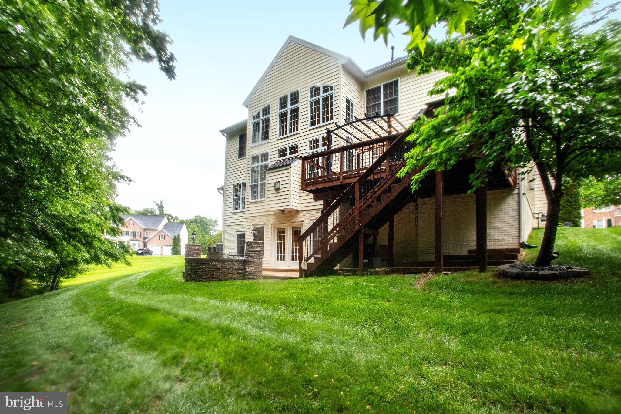 18565 Kerill Road Triangle, VA 22172 - Photo 11 of 59 a front view of a house with a yard and trees