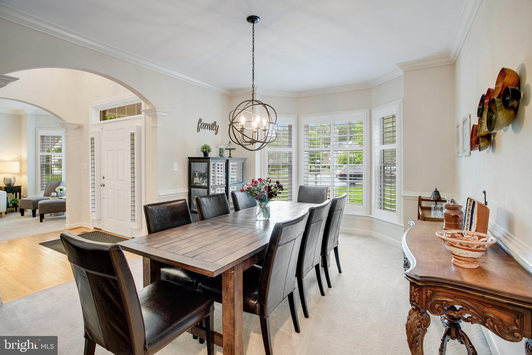 18565 Kerill Road Triangle, VA 22172 - Photo 18 of 59 a view of a dining room with furniture window and wooden floor