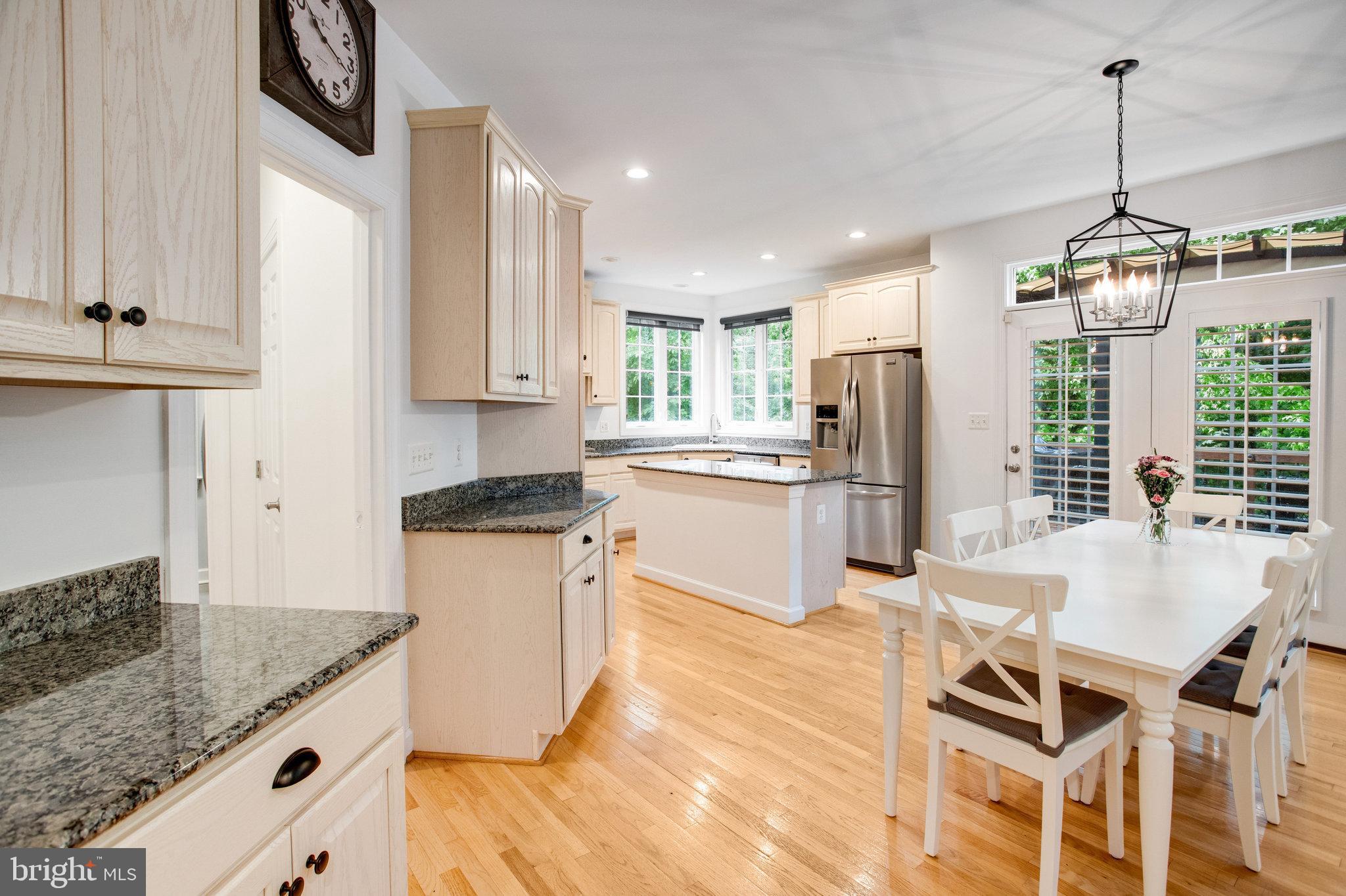 18565 Kerill Road Triangle, VA 22172 - Photo 32 of 59 a kitchen with granite countertop kitchen island stainless steel appliances a sink a counter top space and cabinets