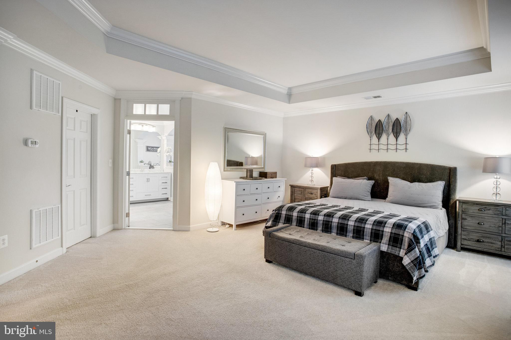 18565 Kerill Road Triangle, VA 22172 - Photo 36 of 59 a spacious bedroom with a bed and window