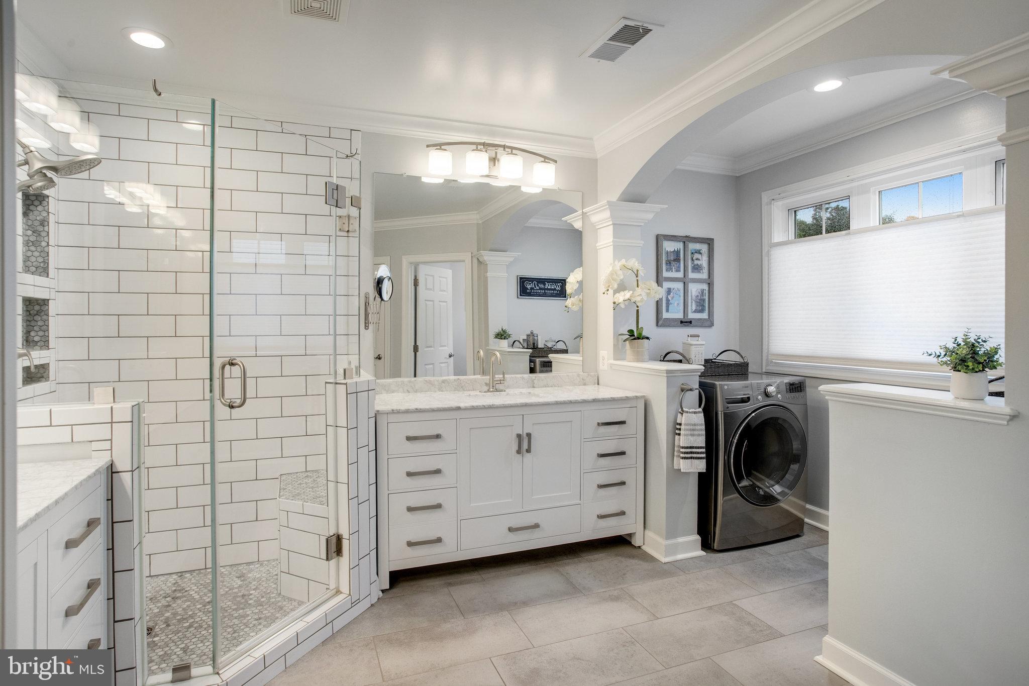 18565 Kerill Road Triangle, VA 22172 - Photo 37 of 59 a bathroom with a double vanity sink a mirror and shower
