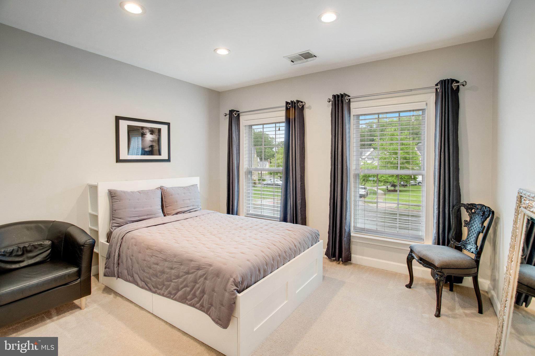 18565 Kerill Road Triangle, VA 22172 - Photo 40 of 59 a bedroom with a bed and a chair