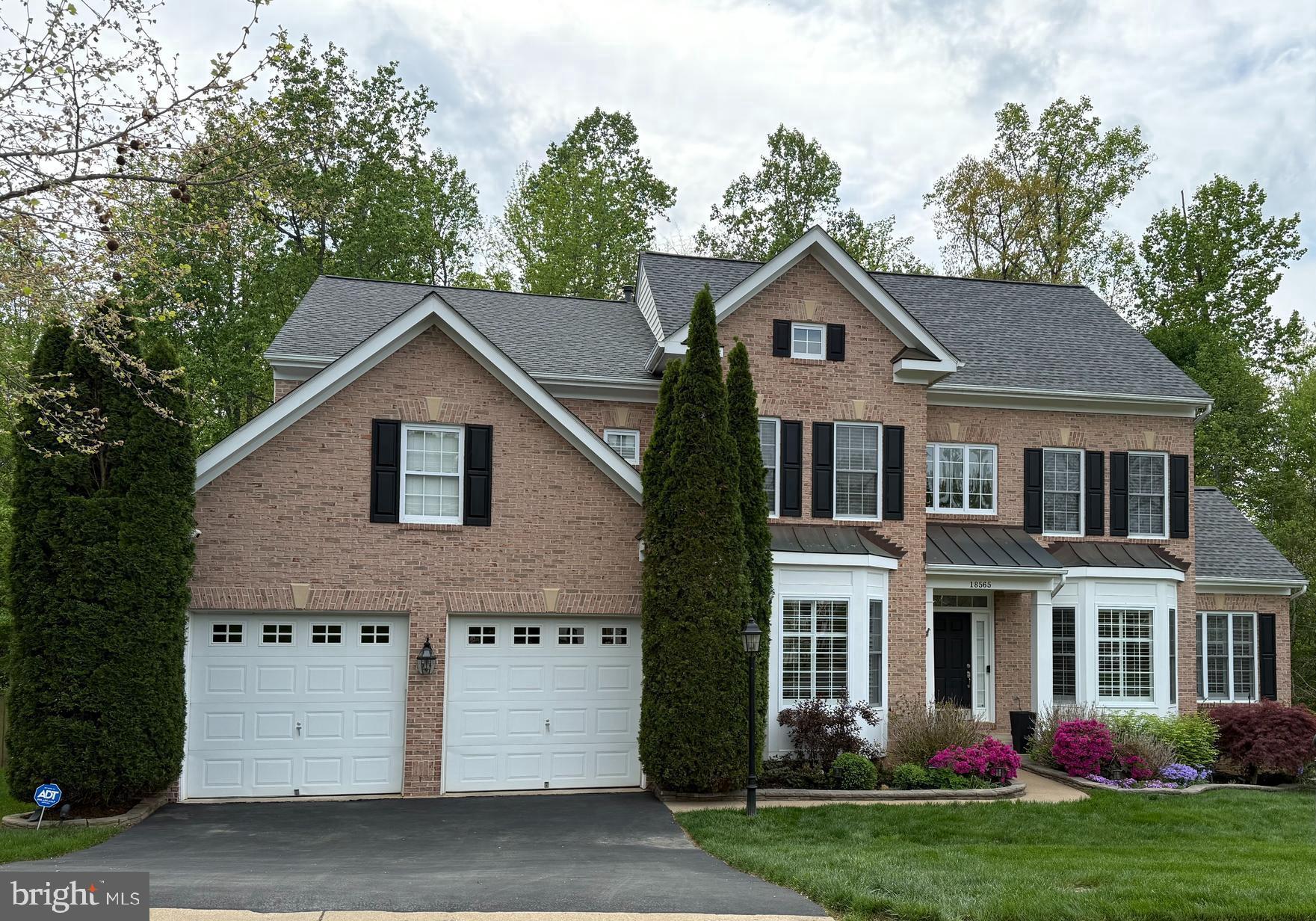 18565 Kerill Road Triangle, VA 22172 - Photo 4 of 59 a front view of a house with a yard and trees