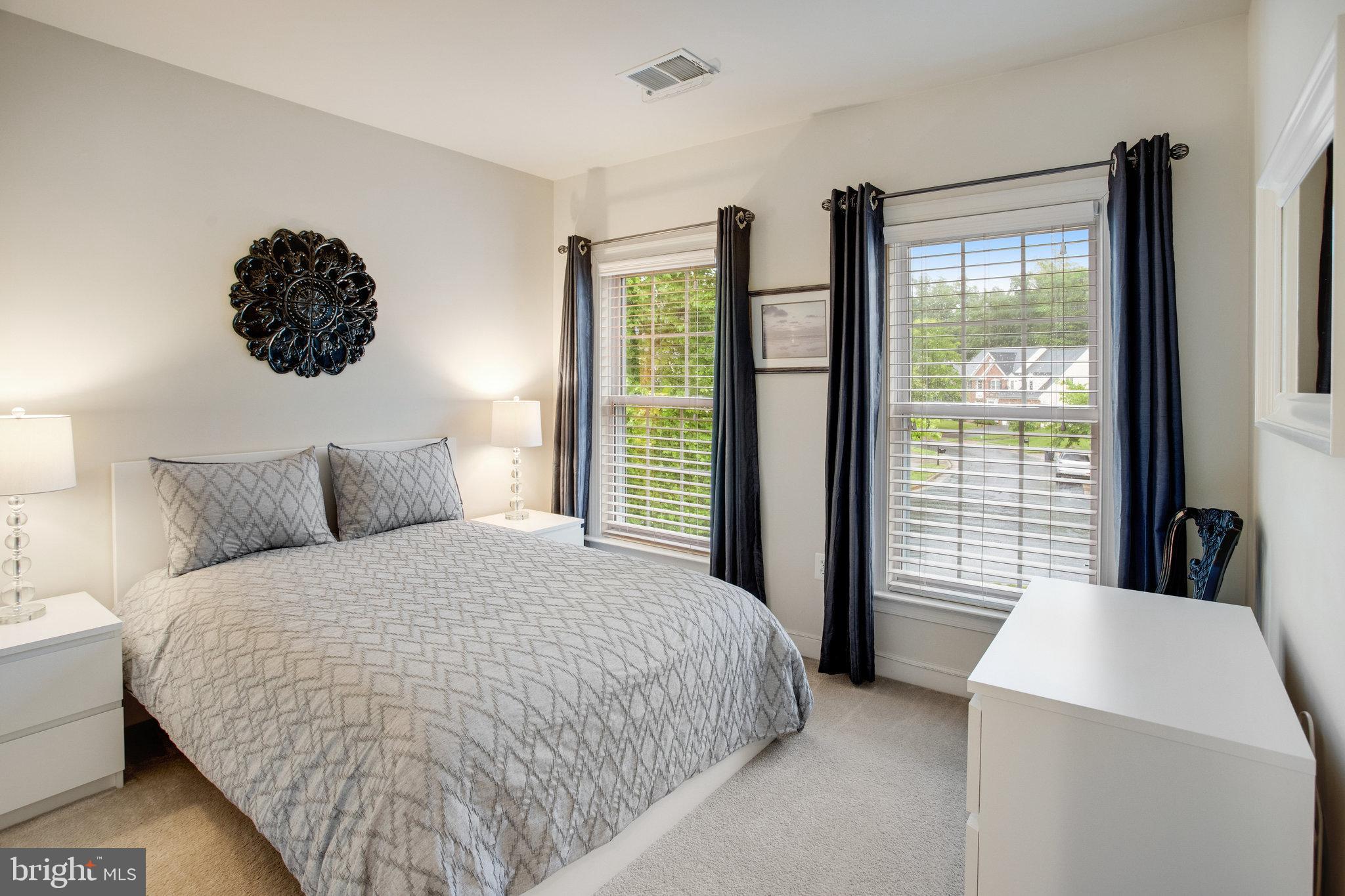 18565 Kerill Road Triangle, VA 22172 - Photo 44 of 59 a bedroom with a large bed and a large window