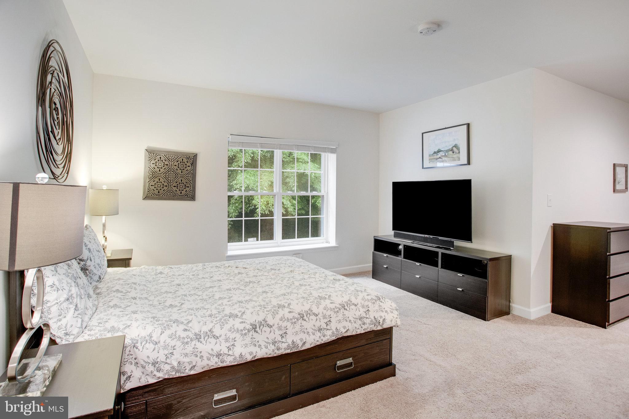 18565 Kerill Road Triangle, VA 22172 - Photo 47 of 59 a bedroom with a bed and a flat screen television