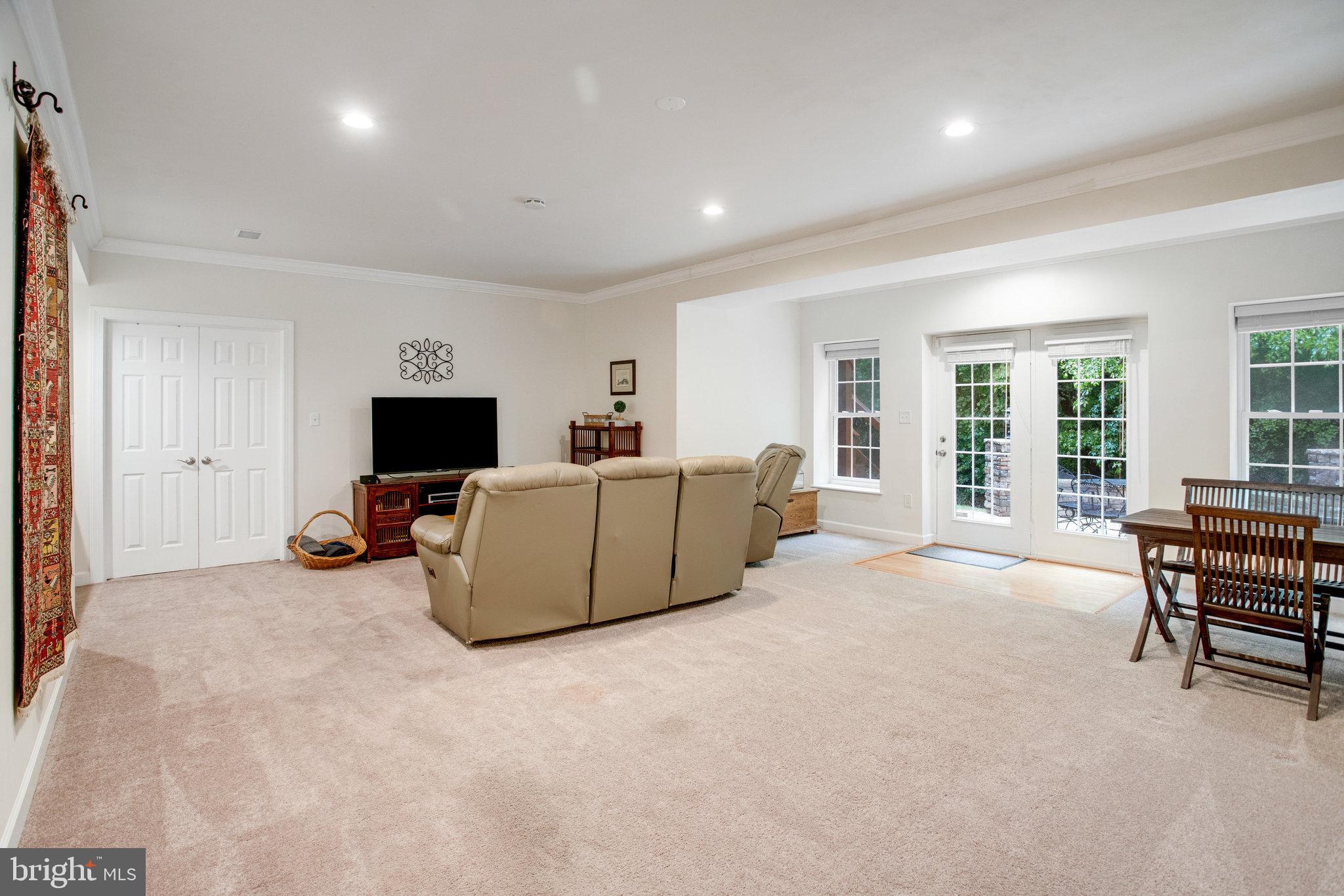 18565 Kerill Road Triangle, VA 22172 - Photo 51 of 59 a living room with furniture and a flat screen tv