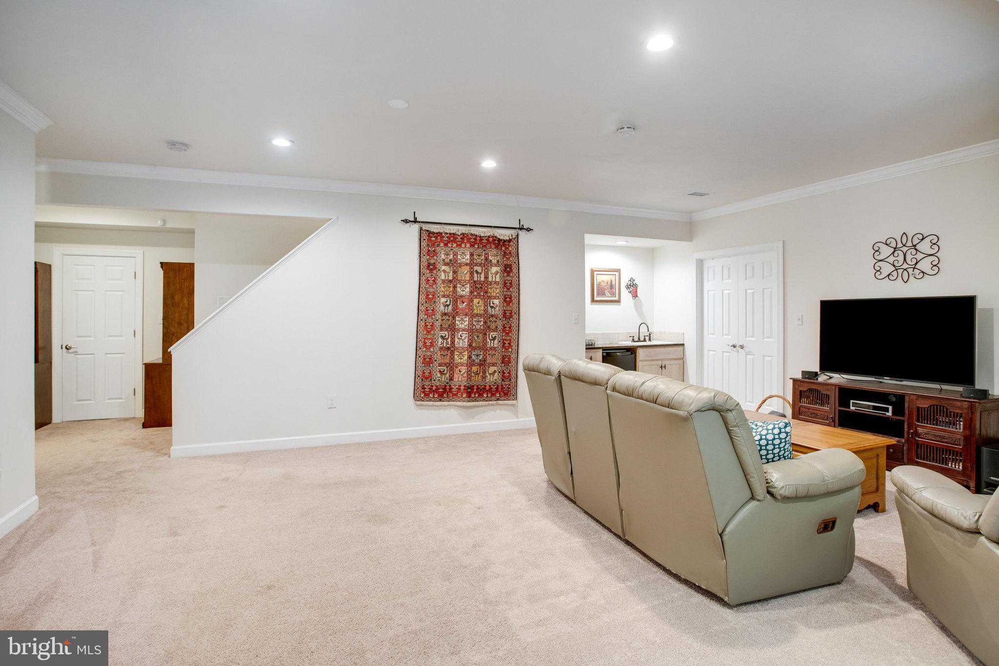18565 Kerill Road Triangle, VA 22172 - Photo 52 of 59 a living room with furniture and a flat screen tv