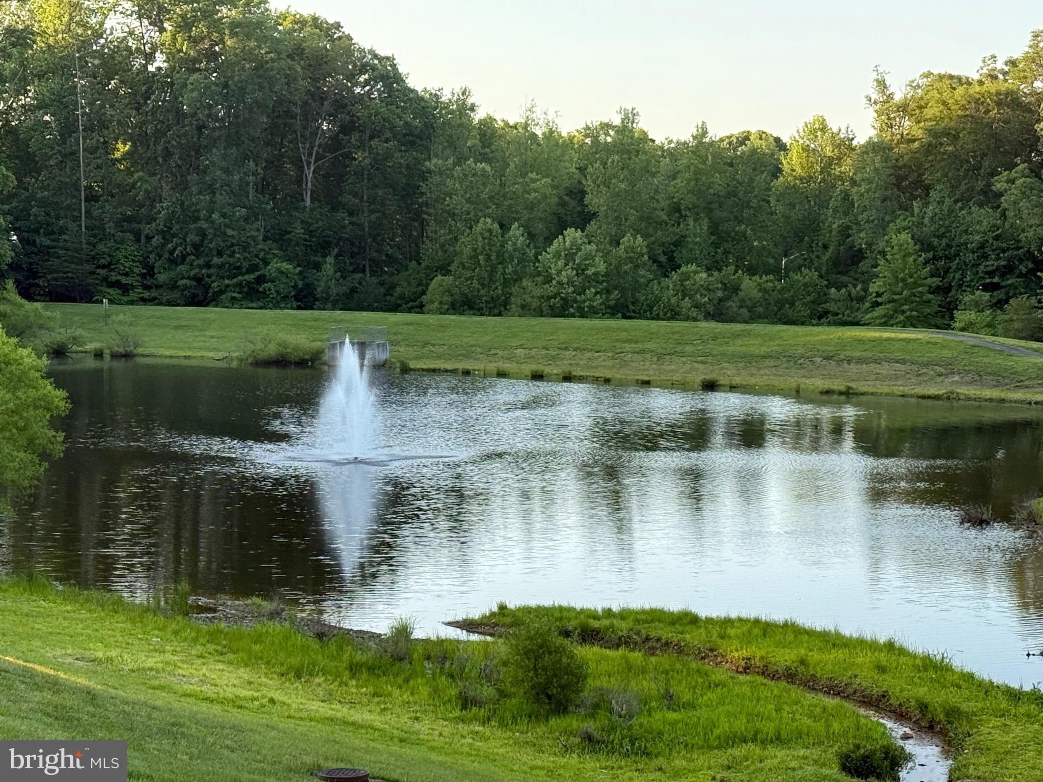 18565 Kerill Road Triangle, VA 22172 - Photo 57 of 59 a view of a lake with a yard