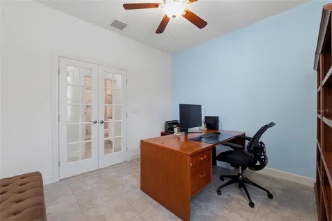 a view of a workspace with furniture and a window