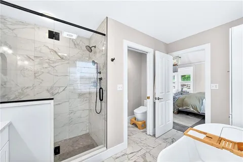 a en suite bathroom with a shower and a sink