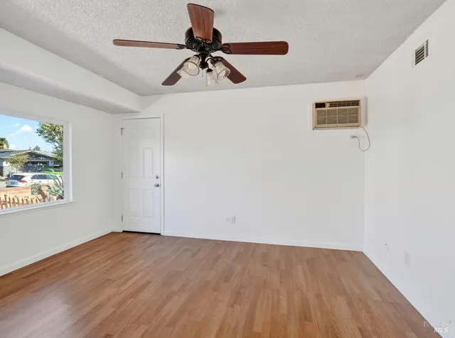 a view of walk in closet with wooden floor
