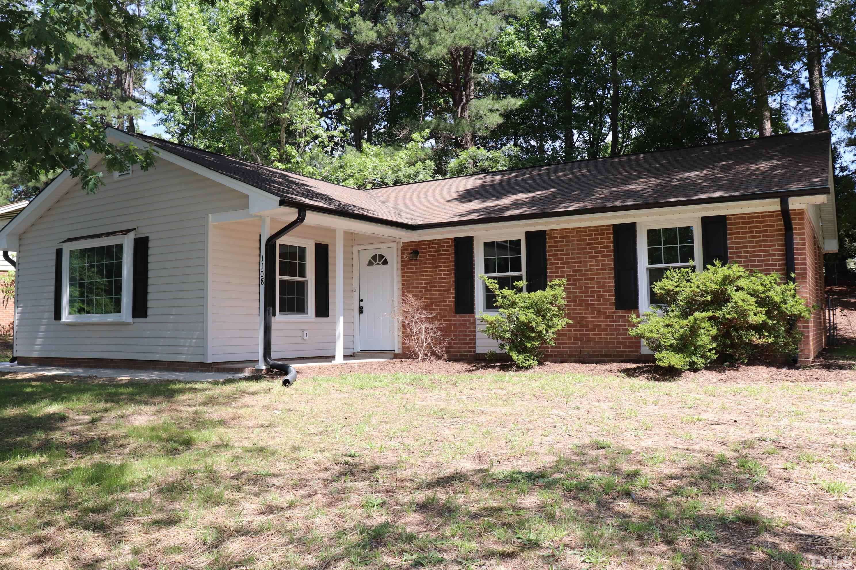 1108 Wyldewood Road Durham, NC 27704 - Photo 1 of 35 a house that has a tree in front of it