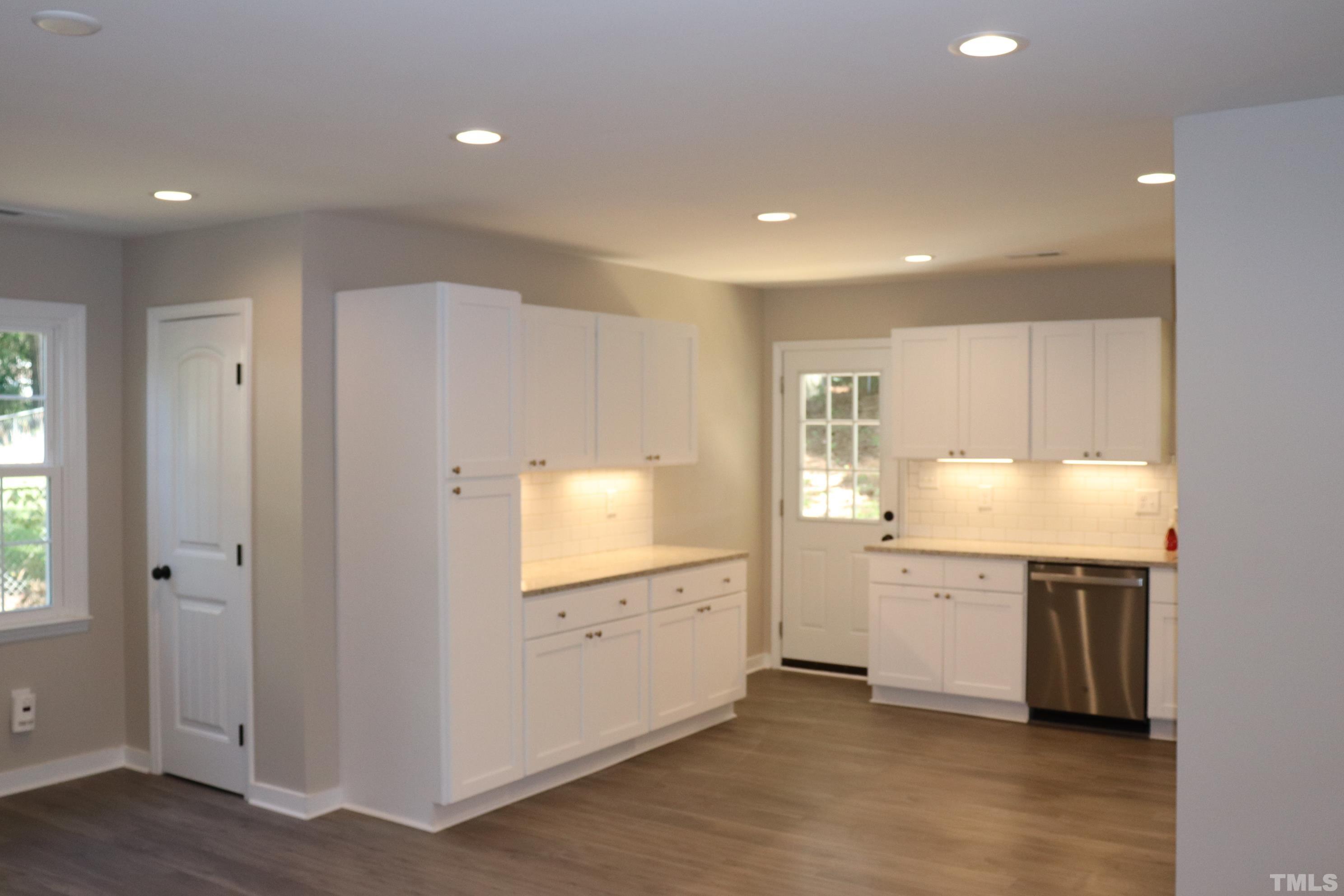 1108 Wyldewood Road Durham, NC 27704 - Photo 11 of 35 a view of a kitchen with a sink cabinet and a window