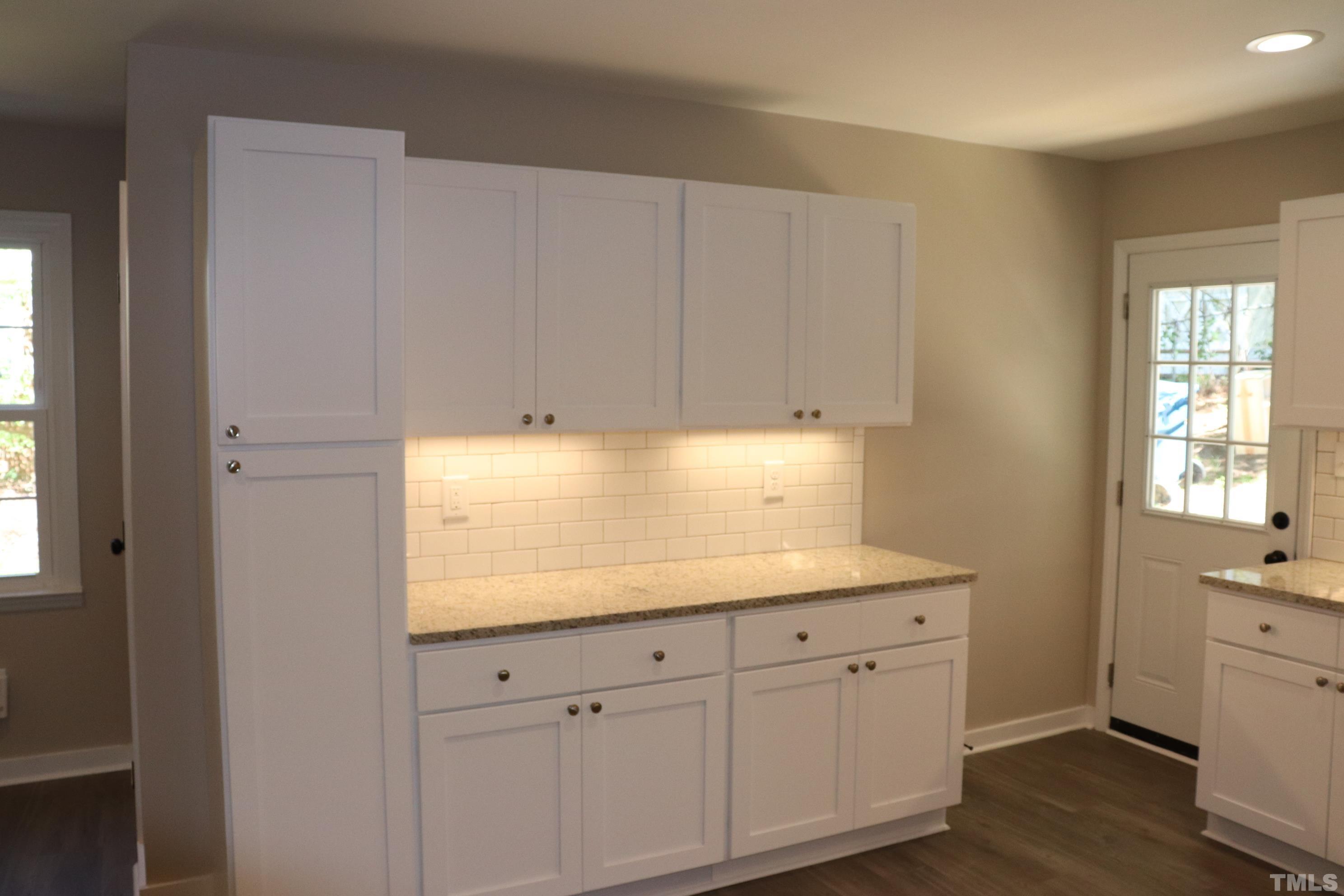 1108 Wyldewood Road Durham, NC 27704 - Photo 14 of 35 a kitchen with white cabinets