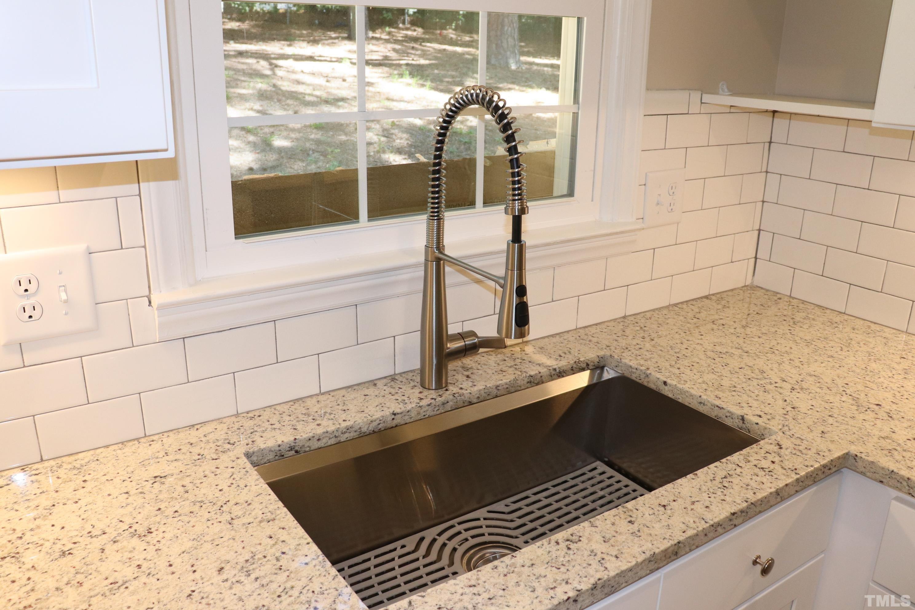 1108 Wyldewood Road Durham, NC 27704 - Photo 15 of 35 a kitchen with a sink and a stove