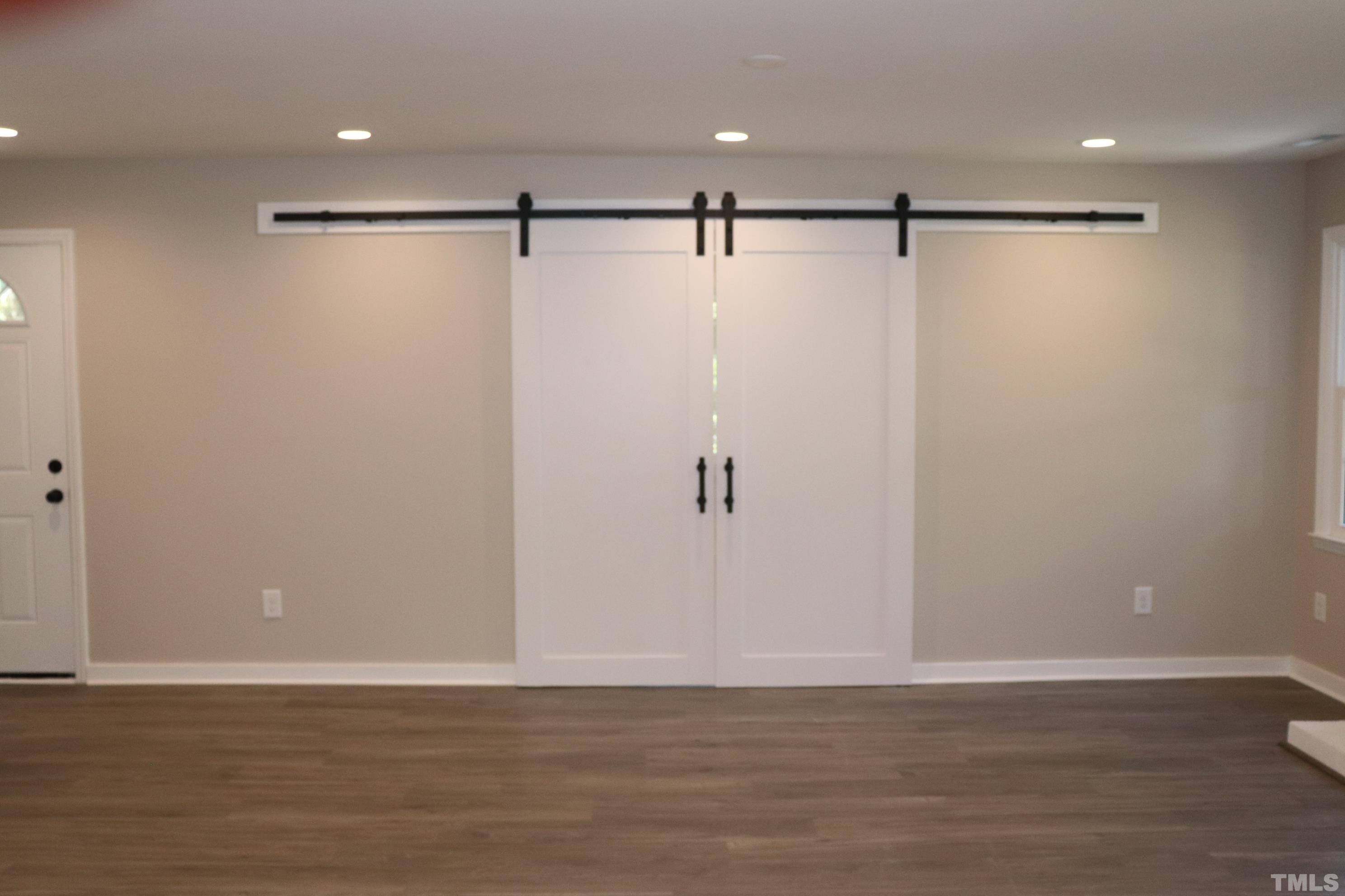 1108 Wyldewood Road Durham, NC 27704 - Photo 16 of 35 a view of an empty room with wooden floor