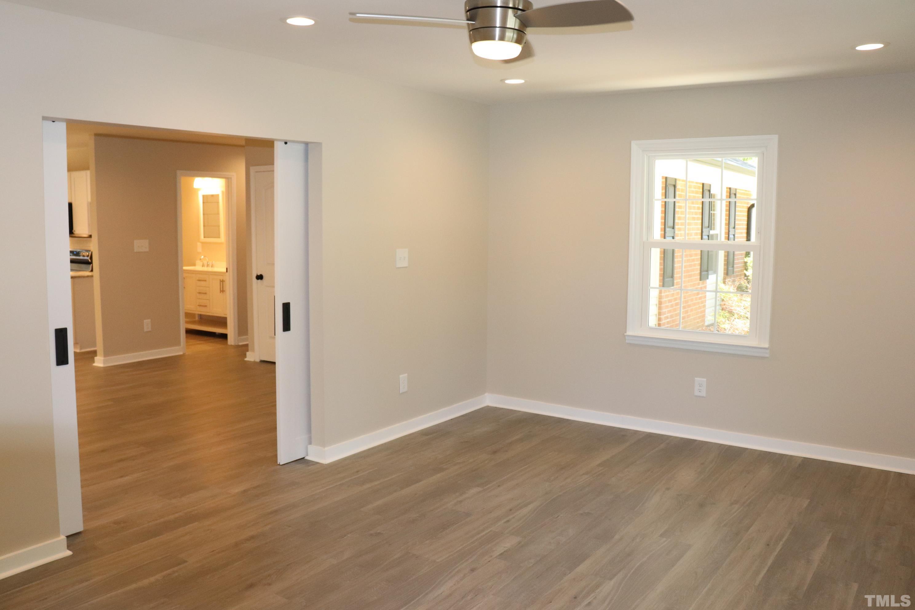 1108 Wyldewood Road Durham, NC 27704 - Photo 25 of 35 wooden floor in an empty room with a window