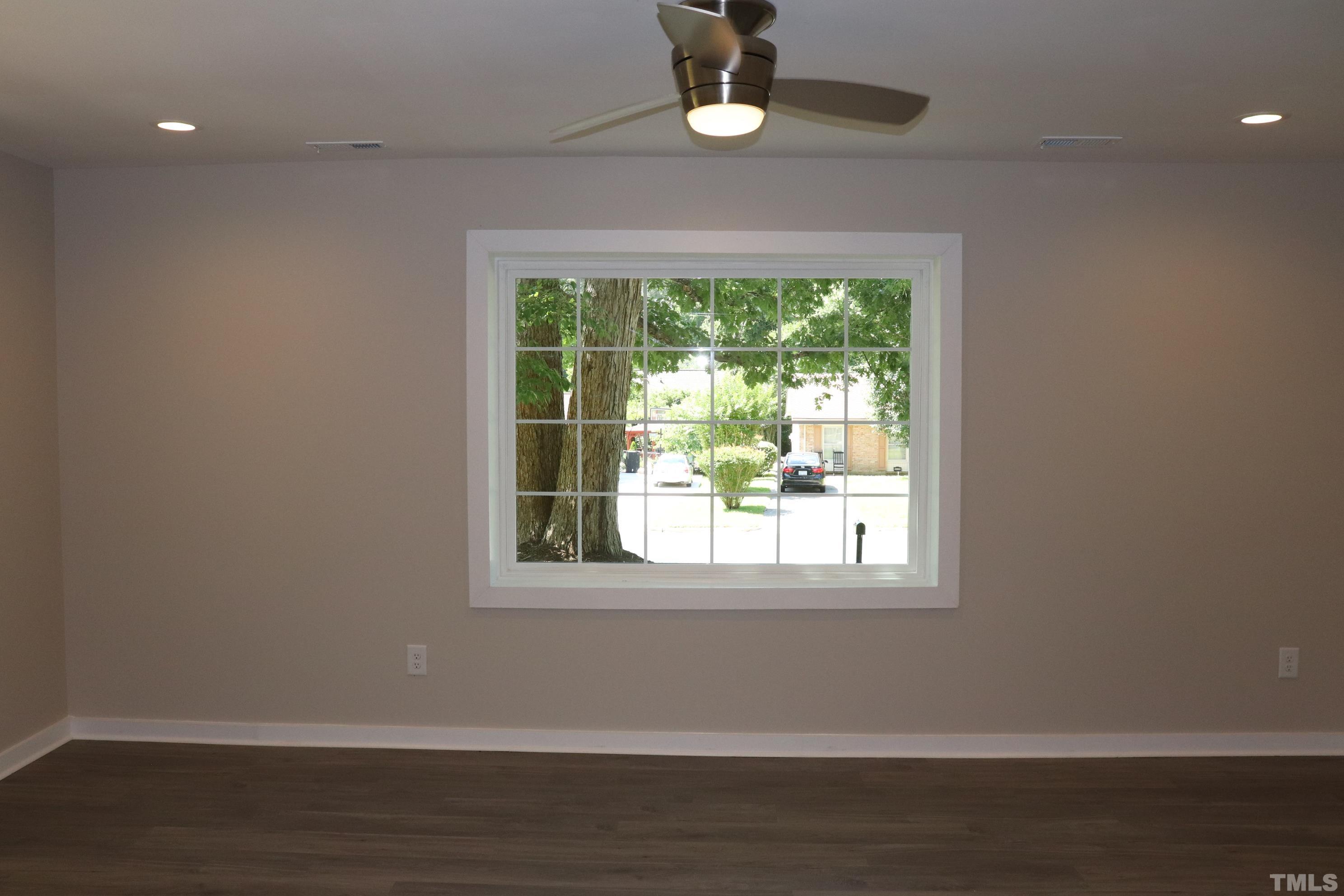 1108 Wyldewood Road Durham, NC 27704 - Photo 26 of 35 a view of an empty room with wooden floor and a window